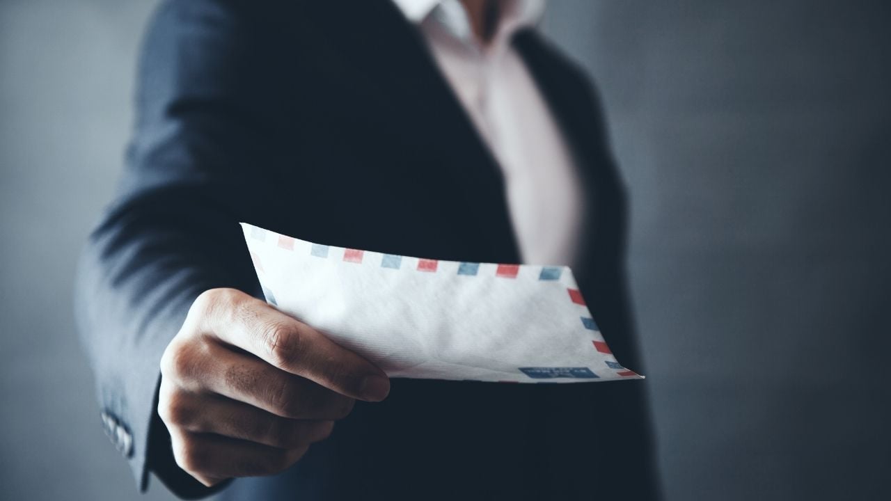 Man handing a letter